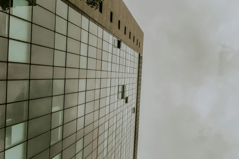 a plane flying through a cloudy sky next to a tall building, a photo, inspired by Richard Wilson, pexels contest winner, brutalism, square lines, glass wall, front side, frontal picture