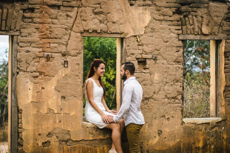 a man and a woman sitting on a window sill, by Lucia Peka, pexels contest winner, at the stone ruins, lachlan bailey, avatar image, rustic