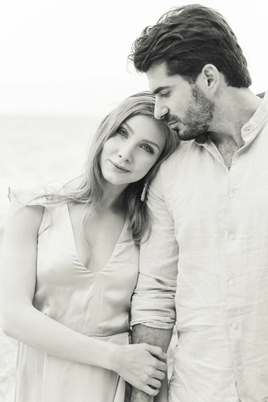 a man and woman standing next to each other on a beach, a black and white photo, by Silvia Pelissero, renaissance, soft portrait shot 8 k, instagram picture, gregoire and manon, an elegant couple