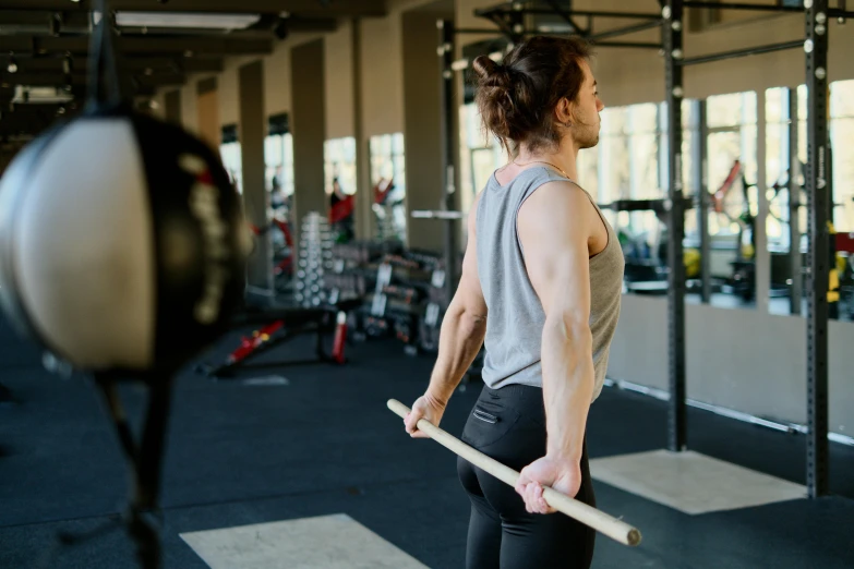 a woman holding a baseball bat in a gym, pexels contest winner, his arms are behind his back, lachlan bailey, gif, high quality photo