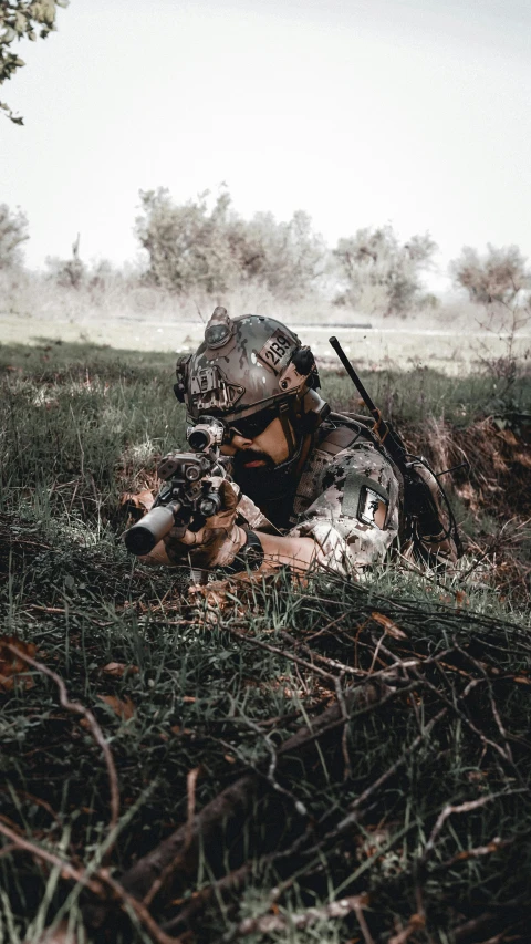 a man sitting in the grass with a dog, by Adam Marczyński, pexels contest winner, airsoft cqb, wearing camo, looking at the ground, instagram story