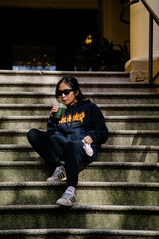 a woman sitting on the steps of a building, trending on r/streetwear, holding hot sauce, darkness and flames, jacky tsai style