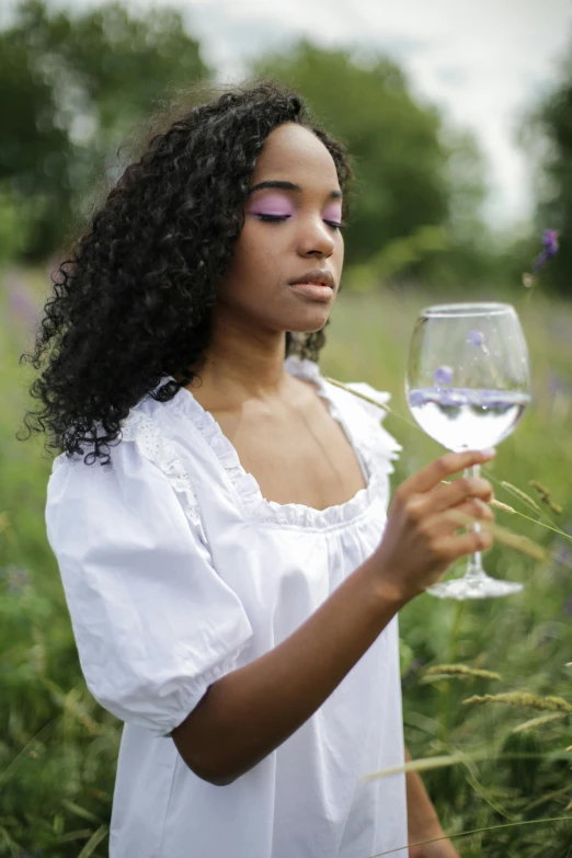 a woman holding a glass of wine in a field, pexels contest winner, renaissance, black young woman, midsommar color theme, promo image, contemplation