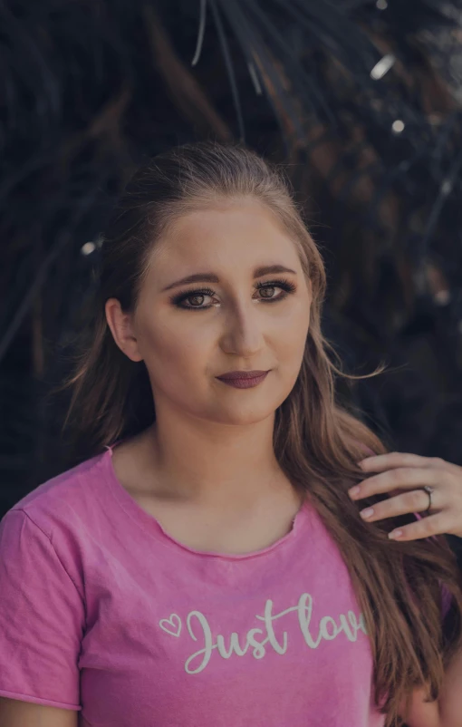 a woman in a pink shirt posing for a picture, a portrait, pexels contest winner, sydney hanson, discord profile picture, desaturated, blonde hair and large eyes