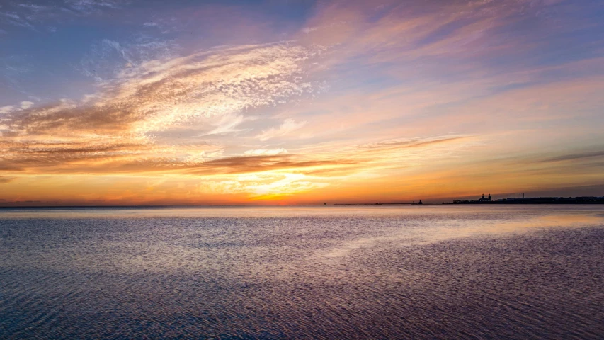 a large body of water with a sunset in the background, by Julian Allen, pexels contest winner, panoramic, fan favorite, pastel sky, seaview