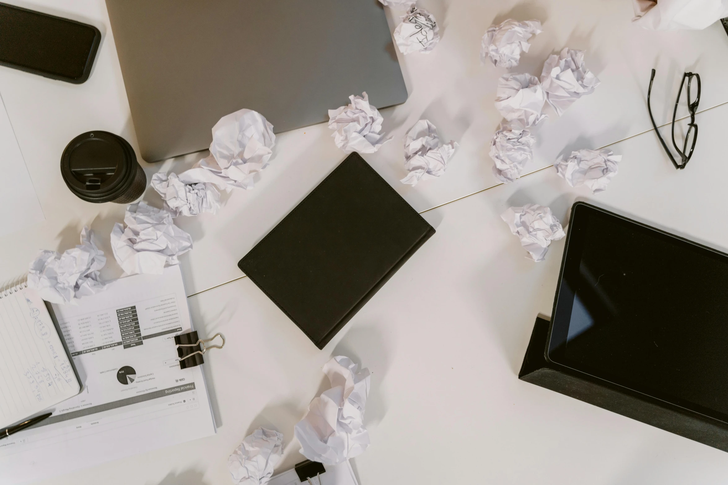 a laptop computer sitting on top of a white desk, by Carey Morris, pexels contest winner, computer art, damage paper, scattered props, black on white paper, background image