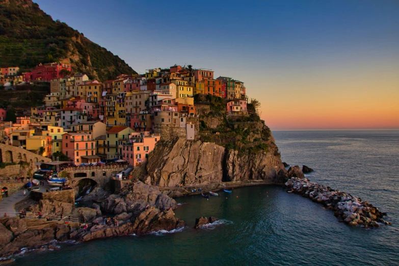 a group of buildings sitting on top of a cliff next to the ocean, pexels contest winner, renaissance, colours of the sunset, rivendell, vouge italy, slide show