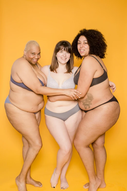 a group of three women standing next to each other, by Arabella Rankin, unsplash, underwear ad, thick body, with grey skin, an enormous