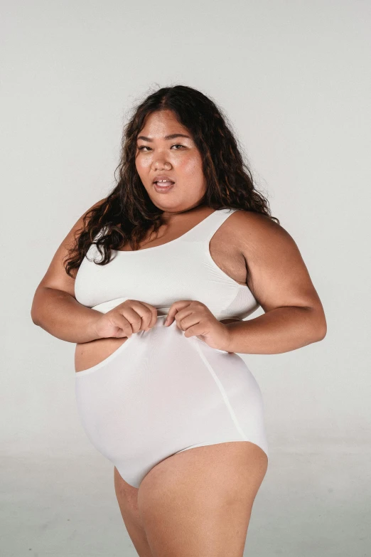 a woman in a white bodysuit posing for a picture, inspired by Ruth Jên, happening, big stomach, indonesia, wearing a tank top and shorts, bbwchan