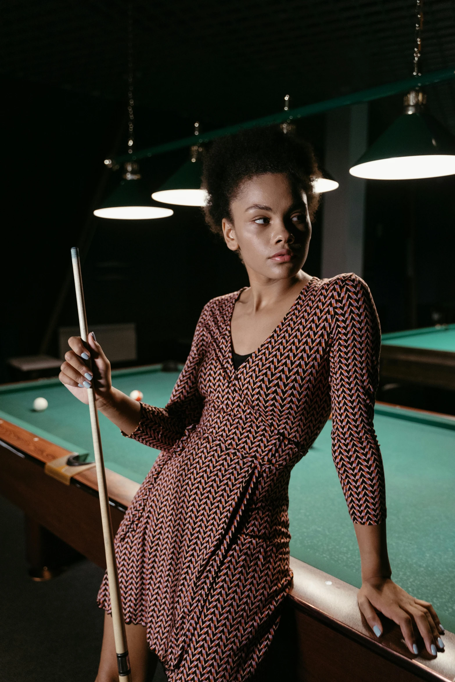 a woman leaning on a pool table with a cue, inspired by Gordon Parks, pexels contest winner, patterned clothing, tessa thompson inspired, tailored clothing, tall shot