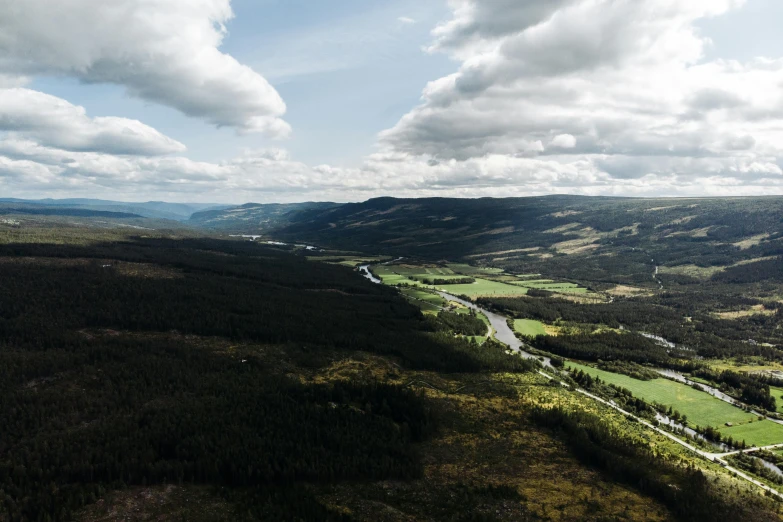 a river running through a lush green valley, by Jesper Knudsen, pexels contest winner, hurufiyya, overlooking a valley with trees, thumbnail, bjørn skalldrasson, ultrawide angle cinematic view