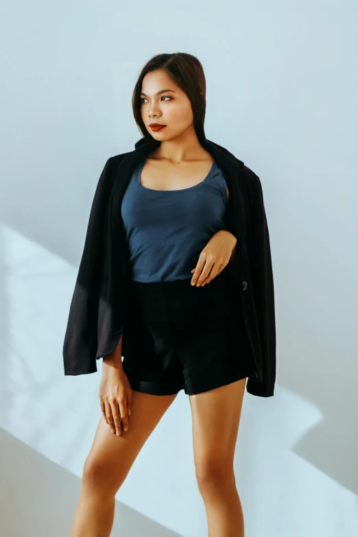 a woman in a blue top and black shorts, unsplash, wearing a black blazer, asian female, light clothing, wearing a black bodysuit