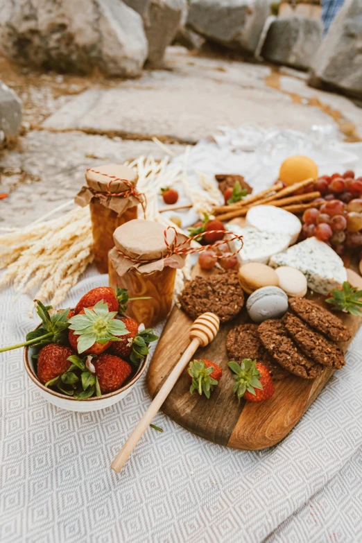 a close up of a plate of food on a table, on a cliff, cheeses, reefs, offering a plate of food