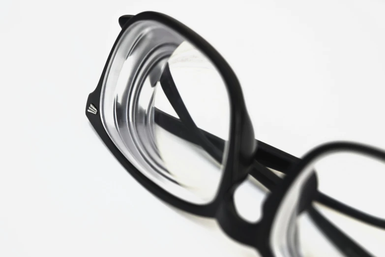 a pair of glasses sitting on top of a table, up close, up-close, product shot, magnified