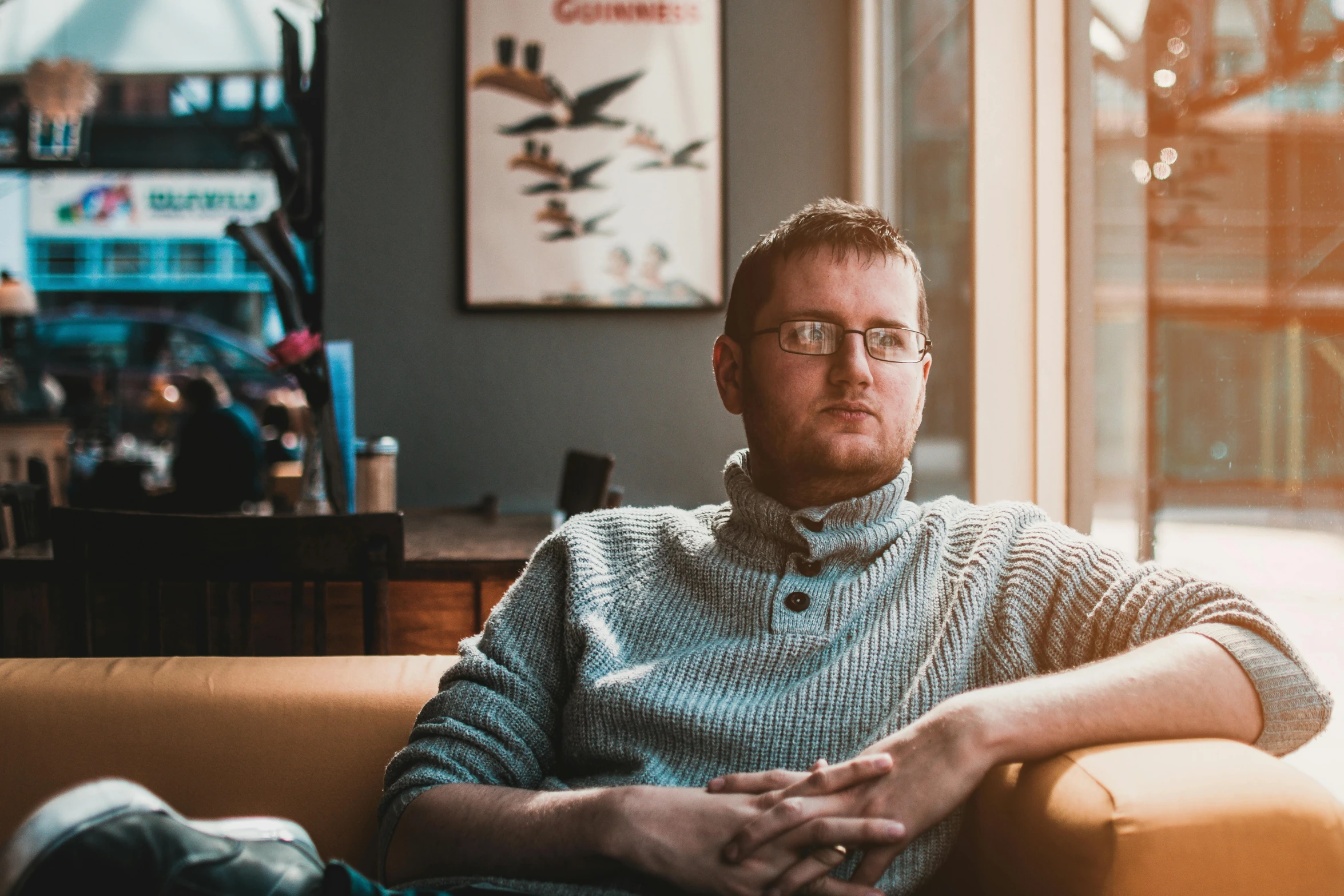 a man sitting on a couch in front of a window, a portrait, pexels contest winner, doug walker, aged 2 5, avatar image, cinematic image