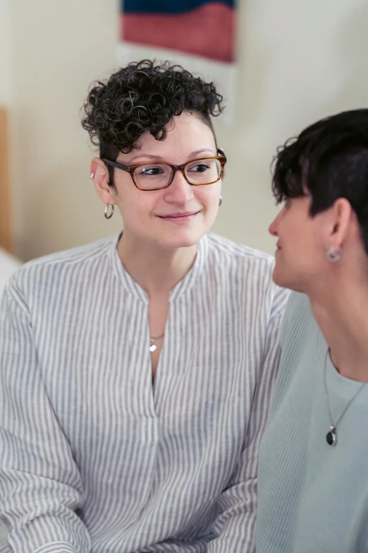 two women sitting on a bed talking to each other, compassionate, curated collections, clinical, transparent