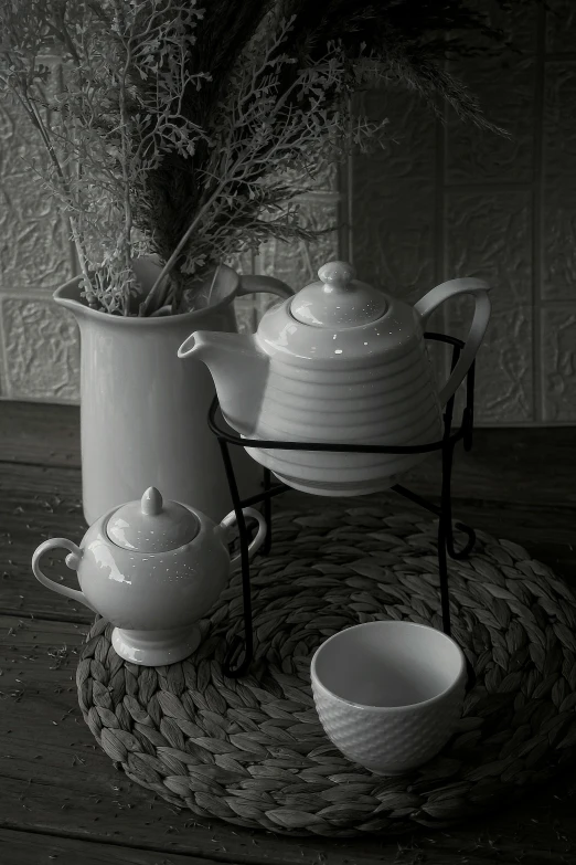 a black and white photo of a tea set, a still life, inspired by Roy DeCarava, pixabay contest winner, rustic setting, white in color, spiralling, ( ( photograph ) )