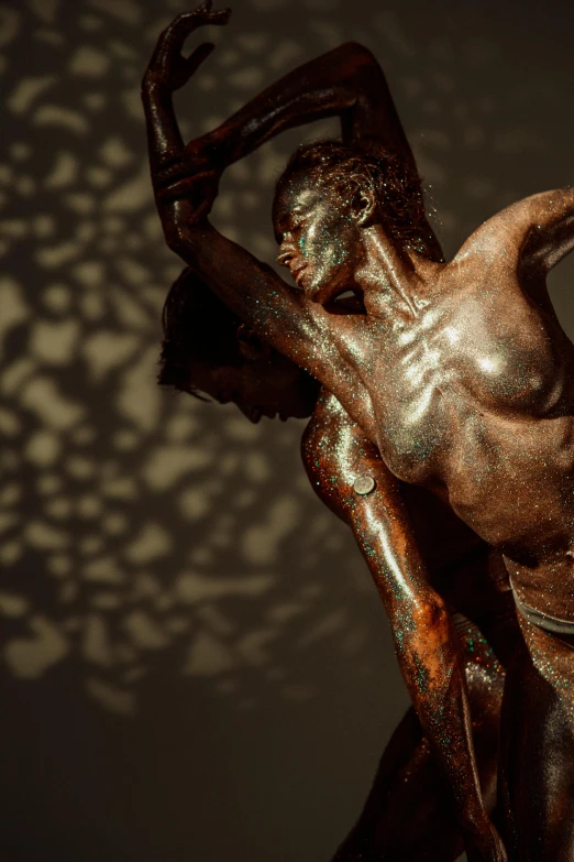 a bronze statue of a man and a woman, inspired by Roberto Ferri, featured on zbrush central, figurative art, sun dappled, vibrant backlit, man is with black skin, lpoty