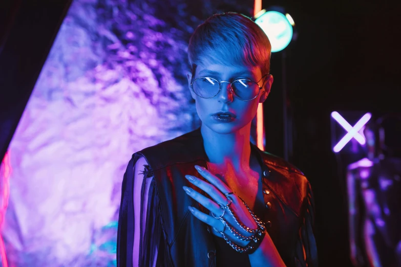 a close up of a person wearing glasses, inspired by Elsa Bleda, blue and purle lighting, night club, androgyny, ad image