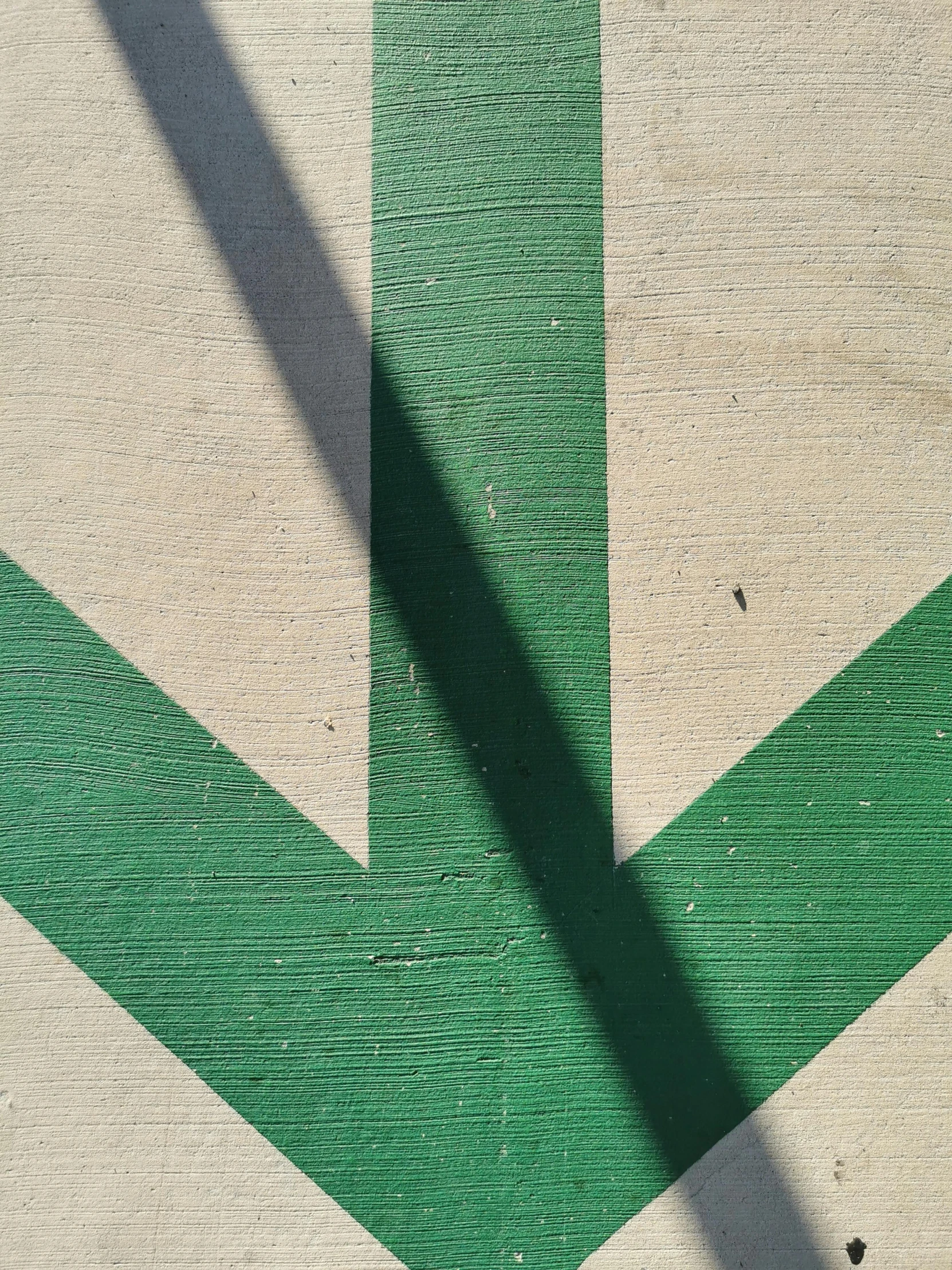 a green arrow painted on the side of a road, an album cover, by Jacob Toorenvliet, unsplash, symbolism, square lines, shadow of catholic church cross, sign, left trad