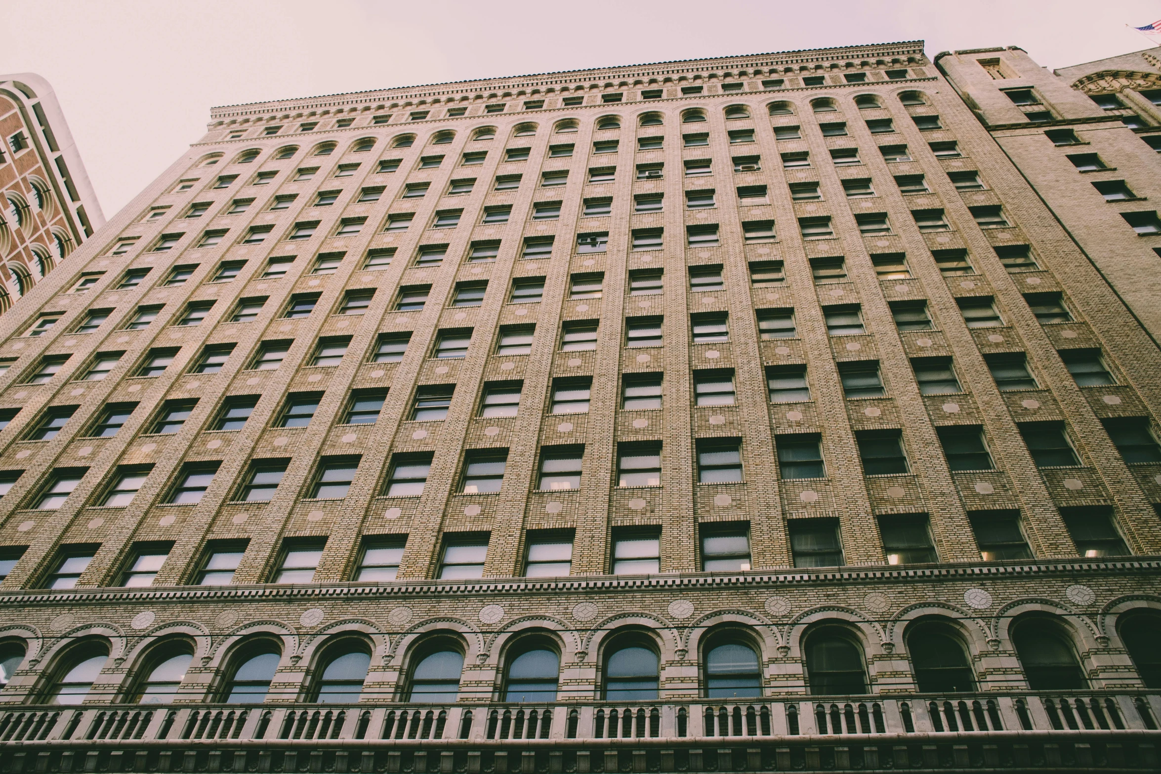 a very tall building with lots of windows, a photo, unsplash, art nouveau, minneapolis, faded, grain”, 90s photo