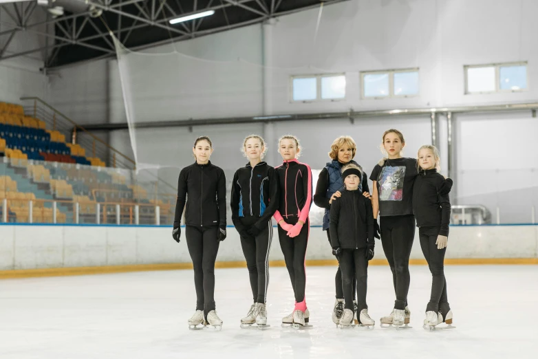 a group of women standing on top of an ice rink, a portrait, unsplash, arabesque, фото девушка курит, cast, low quality photo, irina nordsol kuzmina