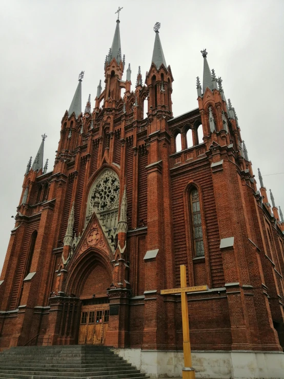 a church with a cross in front of it, majestic spires, black and terracotta, maria panfilova, taken in the early 2020s