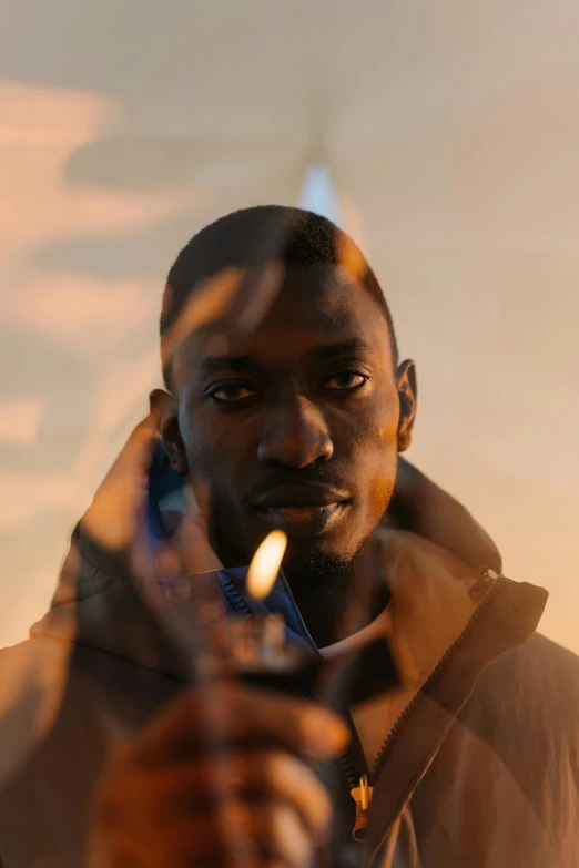 a man holding a cigarette in his hand, an album cover, inspired by Godfrey Blow, pexels contest winner, hyperrealism, adut akech, human torch, light haze, confident looking