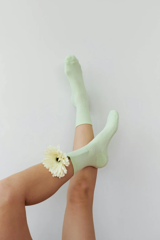 a woman's legs with green socks and a flower, instagram, pale green glow, curated collections, full product shot, vanilla