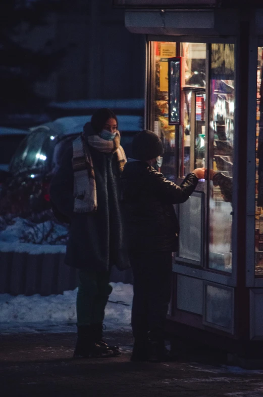 a couple of people standing in front of a store, by Adam Marczyński, pexels contest winner, cold freezing nights, vending machine, 2 0 2 1 cinematic 4 k framegrab, moscow