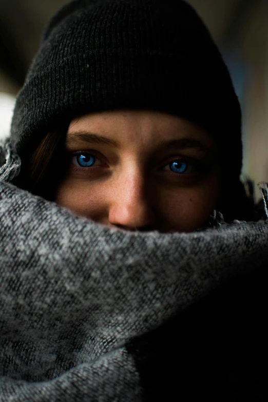 a close up of a person wearing a scarf, by Tobias Stimmer, pexels contest winner, intense blue eyes, extreme cold, avatar image, sheltered