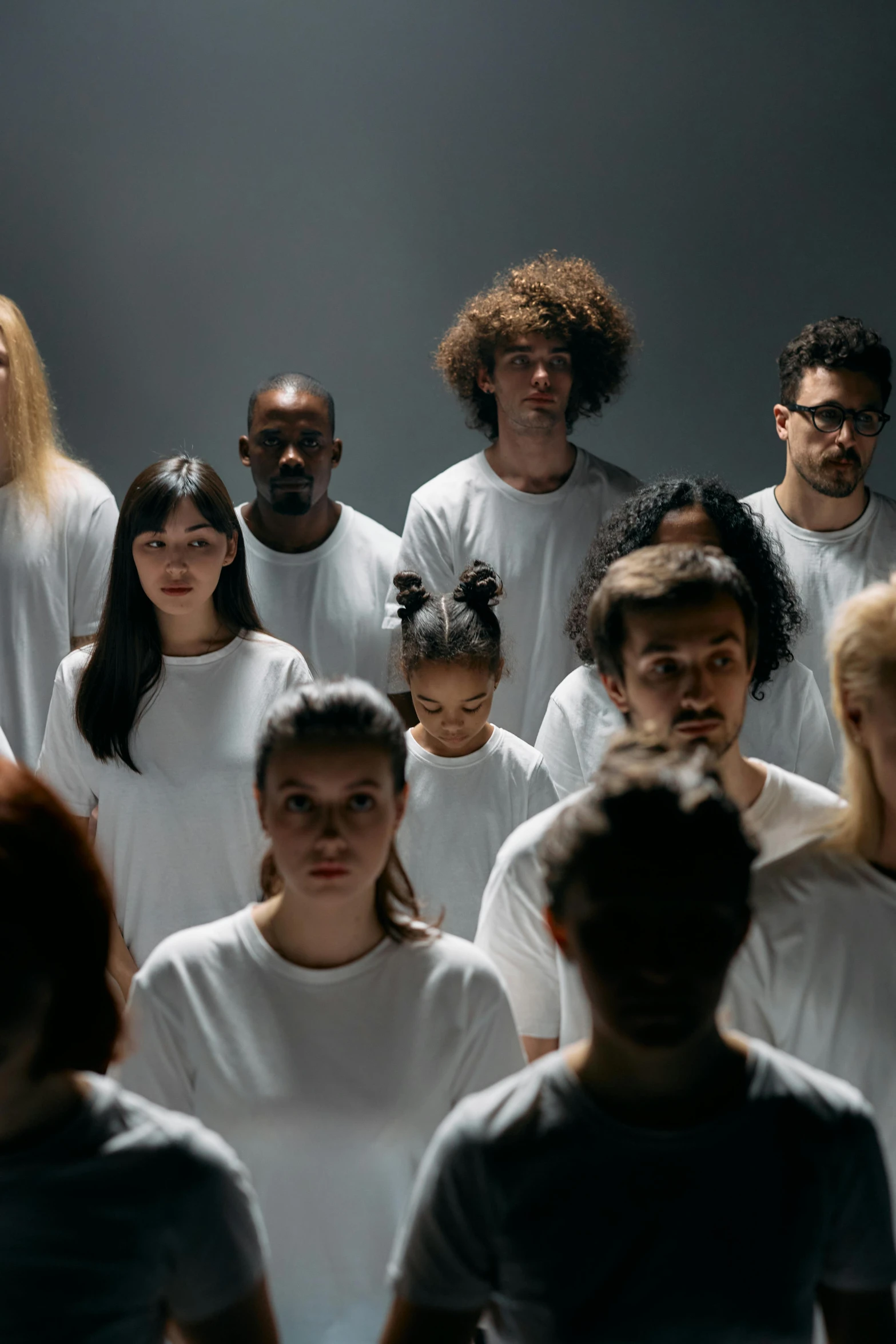 a group of people standing next to each other, inspired by Vanessa Beecroft, pexels contest winner, antipodeans, dressed in a white t-shirt, mixed race, choir, futuristic