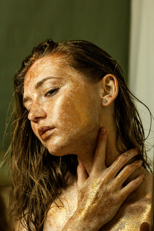 a woman standing in front of a mirror covered in gold paint, inspired by Elsa Bleda, trending on pexels, sweaty wet skin, girl with brown hair, covered in dirt, sydney sweeney