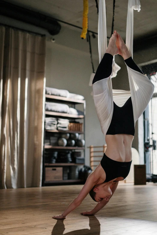 a woman doing a handstand on a hammock, trending on pexels, arabesque, in a gym, wētā fx, full frame image, square