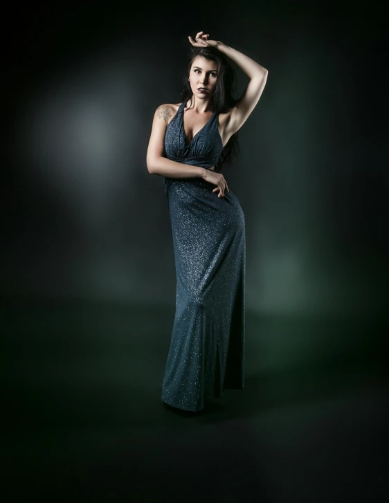 a woman in a blue dress posing for a picture, by Dan Luvisi, art photography, in gunmetal grey, wearing an evening gown, 5 0 0 px models, wide view cinematic lighting