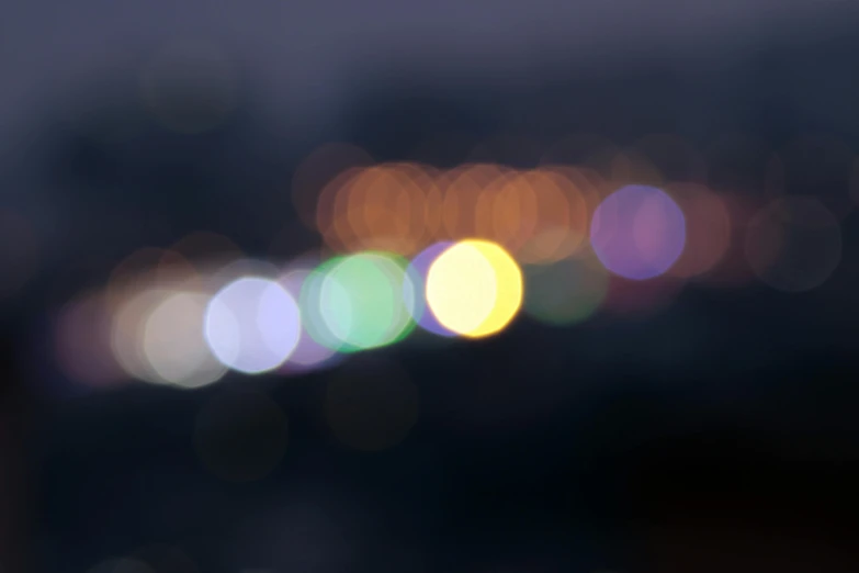 a blurry photo of a city at night, unsplash, overcast bokeh - c 5, multicolored, orbs, soft light - n 9