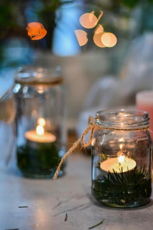 a group of candles sitting on top of a table, inside a glass jar, hanging, medium details, entertaining