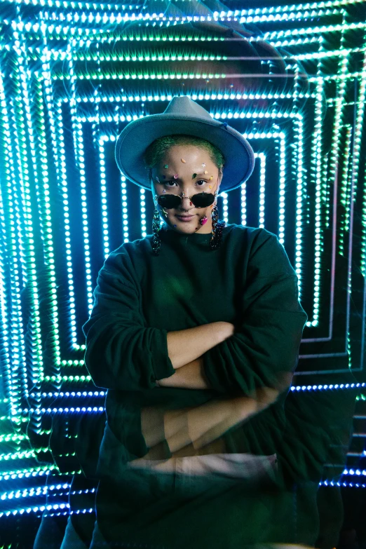 a man in a hat and sunglasses posing for a picture, a hologram, by Julia Pishtar, vivid green lasers, powerful woman sitting in space, hito steyerl, 💣 💥💣 💥