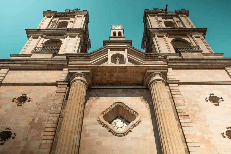 a tall building with a clock on the front of it, pexels contest winner, baroque, shipibo, chrome cathedrals, albuquerque, large pillars