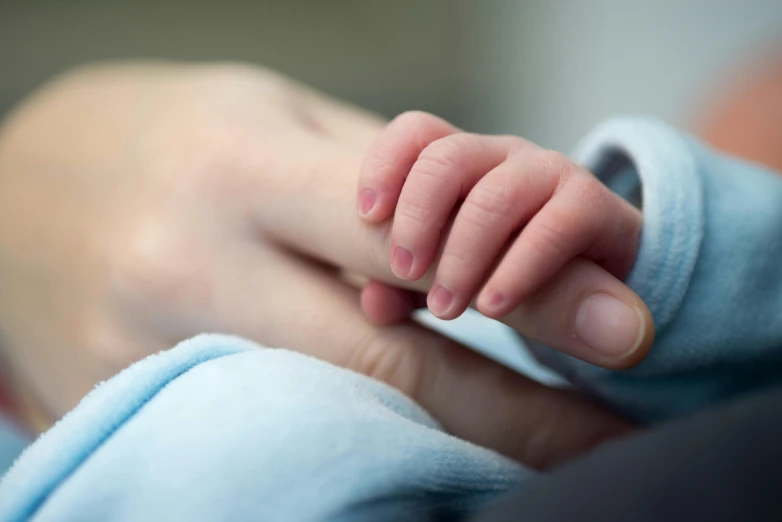 a close up of a person holding a baby's hand, hospital bound, eight eight eight, thumbnail, wētā fx