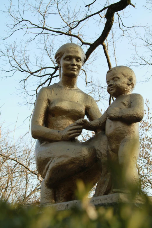 a statue of a woman holding a child, at the park, schomburg, meret elisabeth oppenheim, the non-binary deity of spring