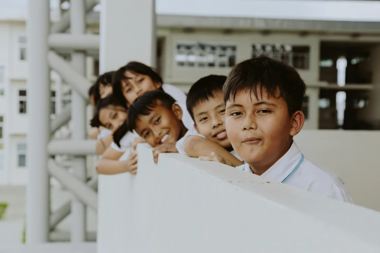 a group of children standing next to each other, pexels contest winner, looking from shoulder, private school, background image, philippines