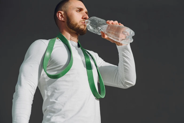 a man in a tie drinking from a water bottle, pexels contest winner, muscular! green, bandolier, sport clothing, no - text no - logo