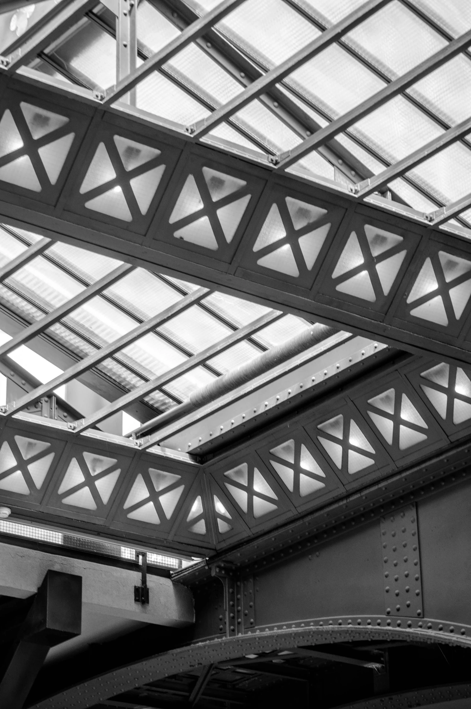 a black and white photo of the inside of a building, a black and white photo, inspired by Edward Wadsworth, flickr, red trusses, aluminum, station, detail structure