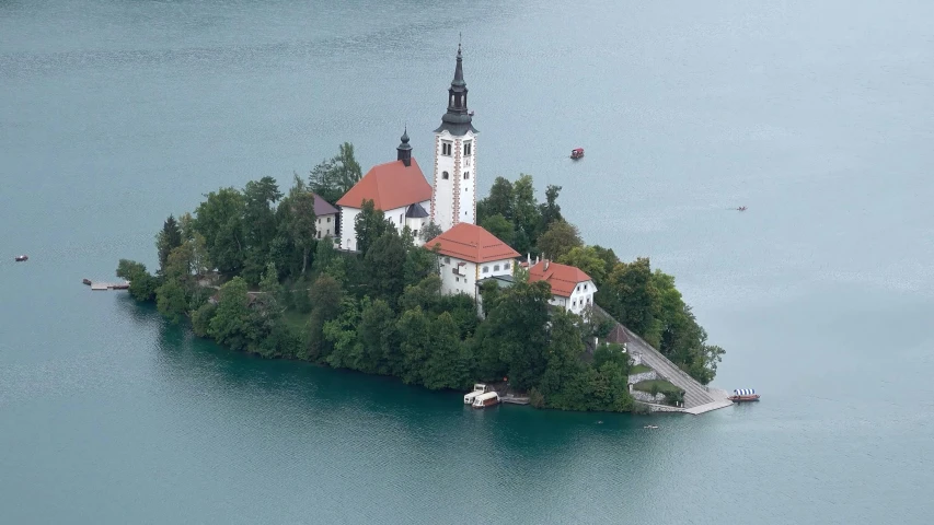 a small island with a church on top of it, inspired by Jan Kupecký, pexels contest winner, helicopter view, slovenian, thumbnail, high quality print