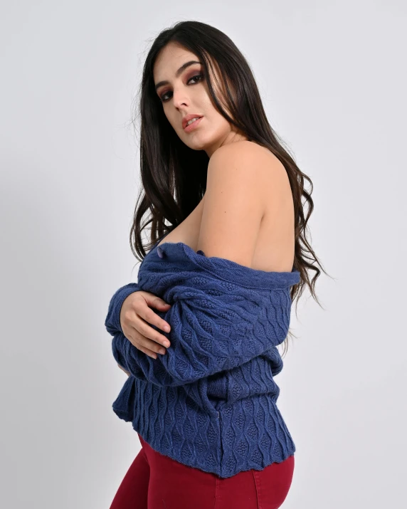a woman wearing a blue sweater and red leggings, by Alejandro Obregón, bralette, profile image, alanis guillen, casual pose