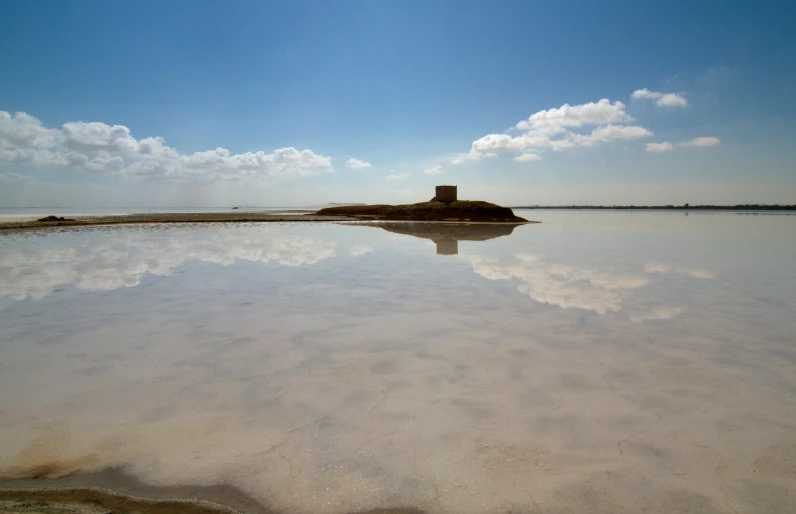 a large body of water sitting on top of a sandy beach, by Peter Churcher, flooded ancient tower, salt dunes, reflect, white salt