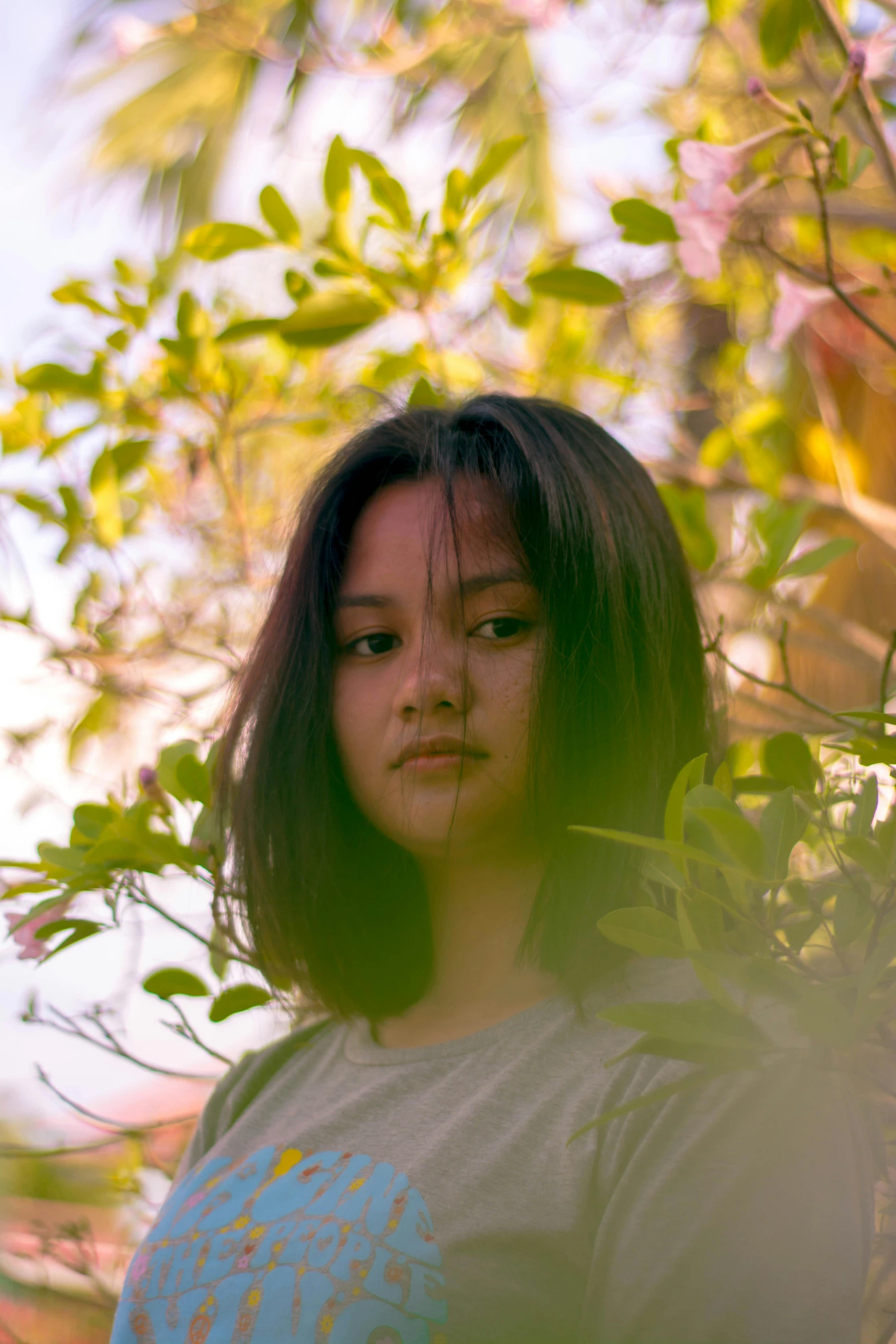 a woman standing in front of a tree, inspired by Elsa Bleda, pexels contest winner, sumatraism, portrait of teen girl, light green tone beautiful face, low quality photo, ((portrait))