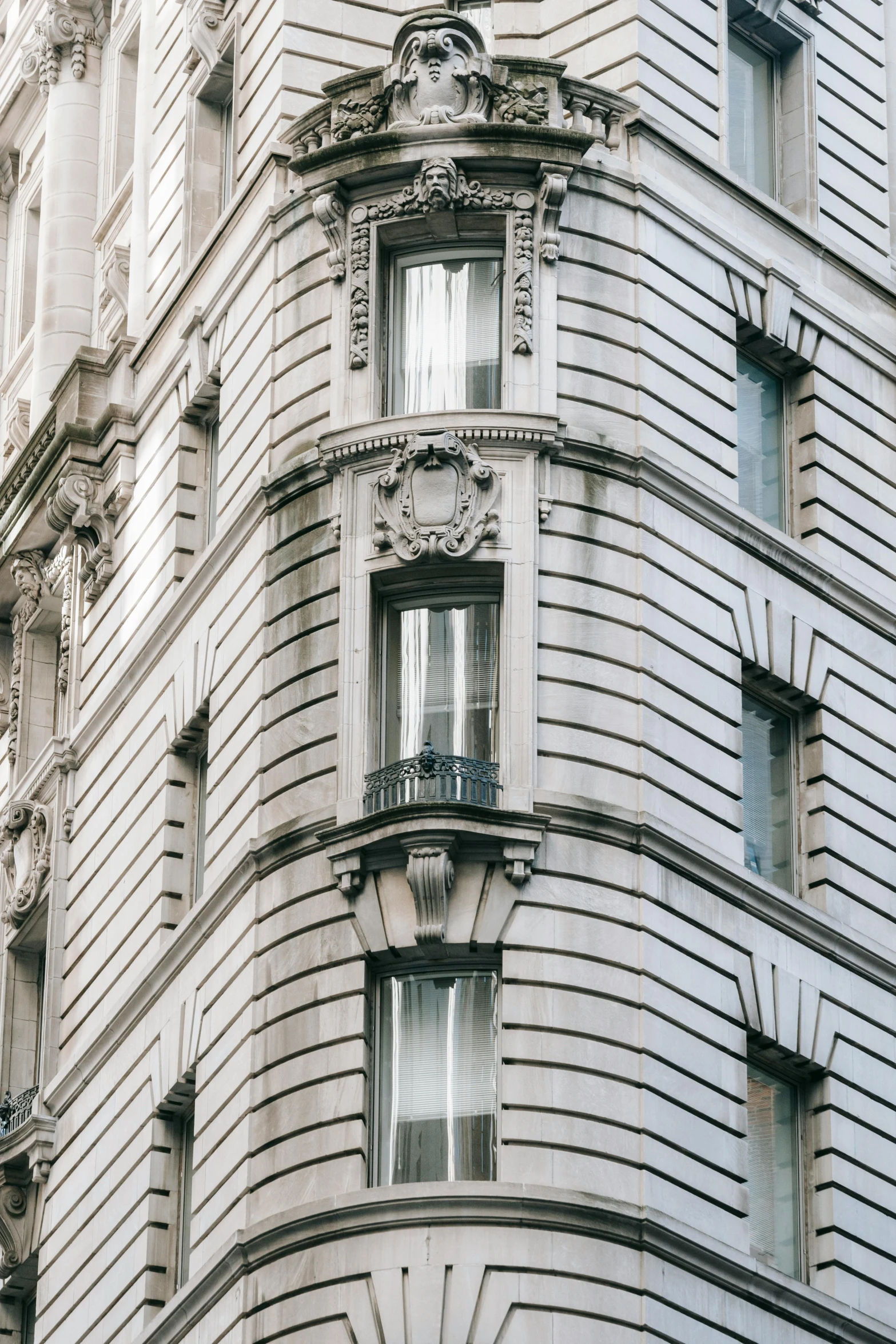 a traffic light hanging from the side of a tall building, trending on pexels, art nouveau, bay window, ornate hair, manhattan, stone facade