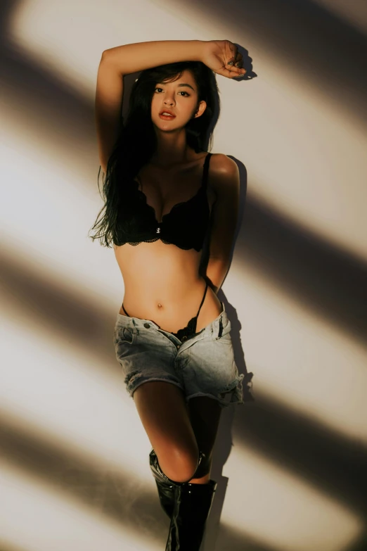 a woman in a black bra top posing for a picture, a picture, inspired by Kim Deuk-sin, nice afternoon lighting, bra and shorts streetwear, promo photo, light effect. feminine